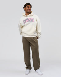 Man wearing Varsity Boxy Hoodie - Off White-Pink Rose | Model:Xav | Size:L | Thumbnail Index: 7