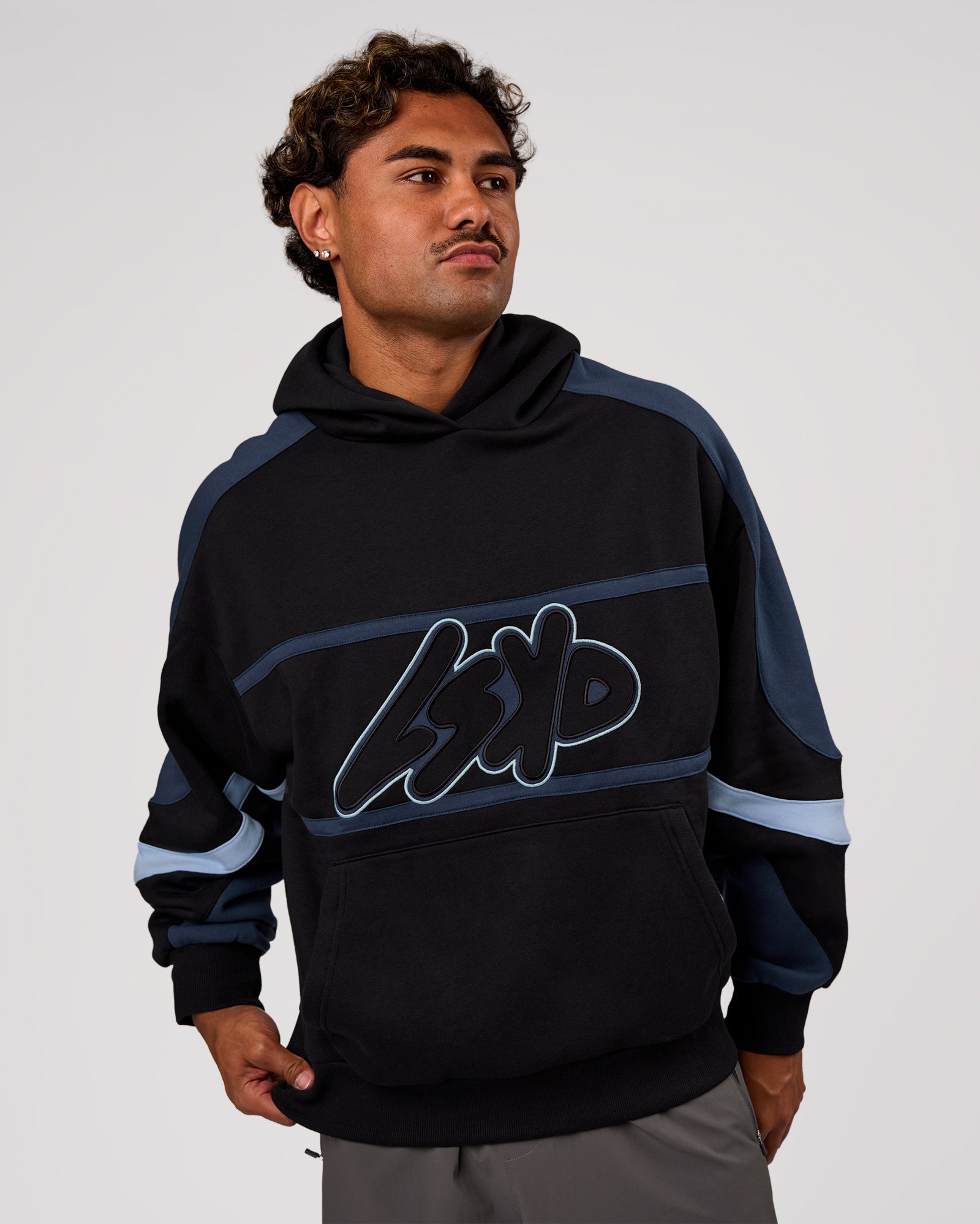 Man wearing Vibe Oversized Hoodie - Black-Future Navy | Model:Xav | Size:L