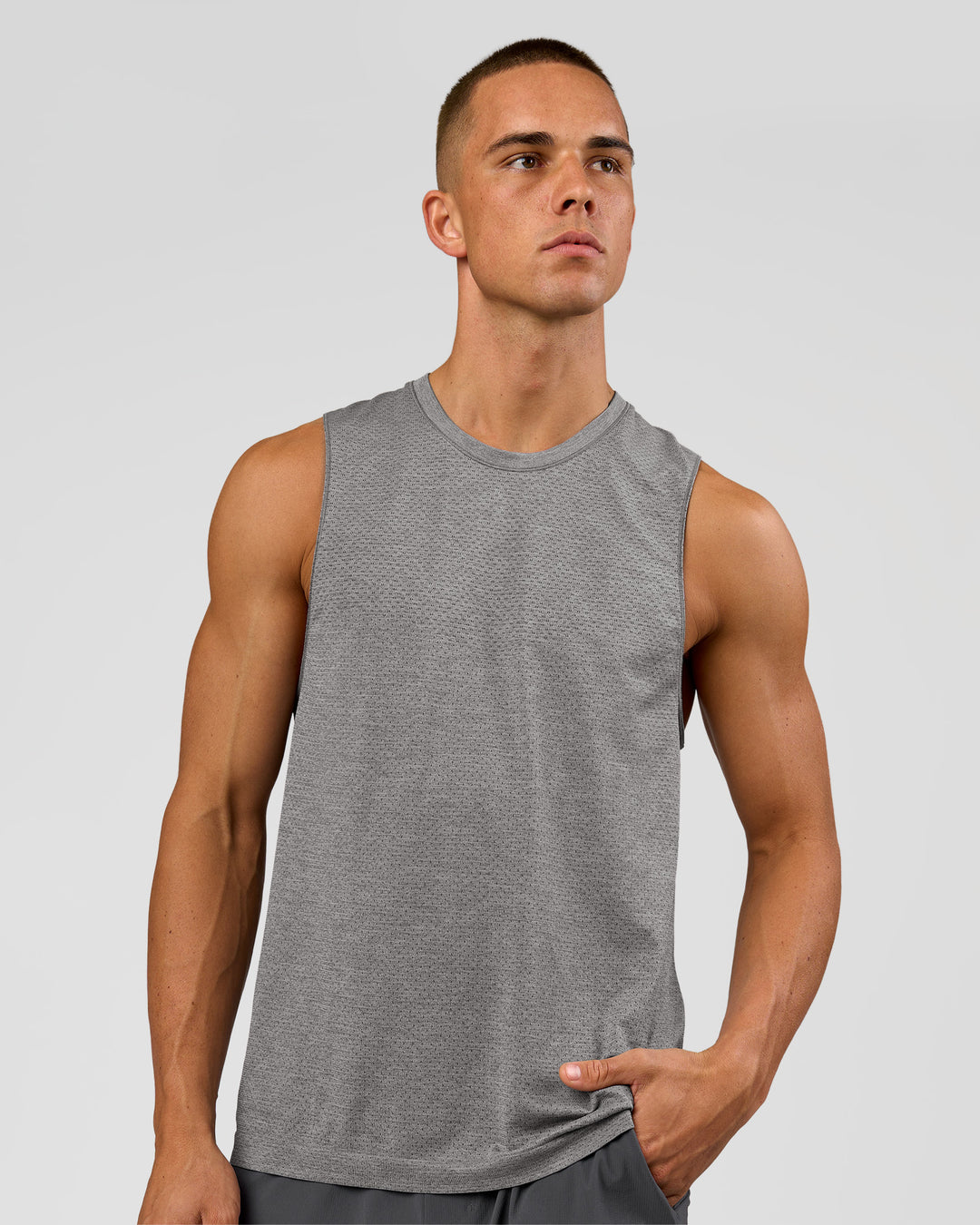 Man wearing AeroFLX+ Seamless Muscle Tank - Dark Storm/Alloy | Model:Albert | Size:M - view 1