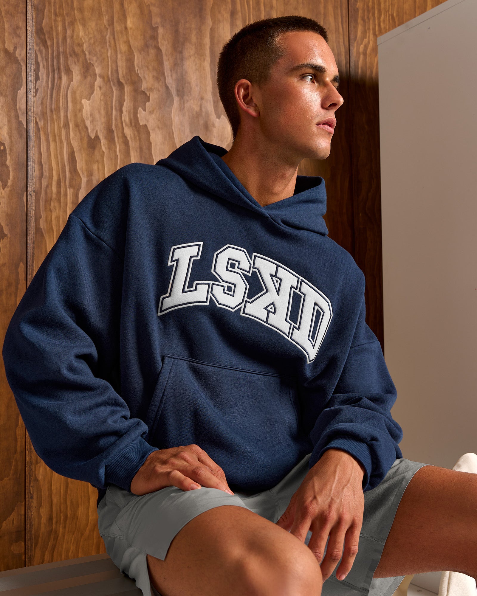 Man wearing Varsity Boxy Hoodie - Future Navy-White | Model:Albert | Size:M