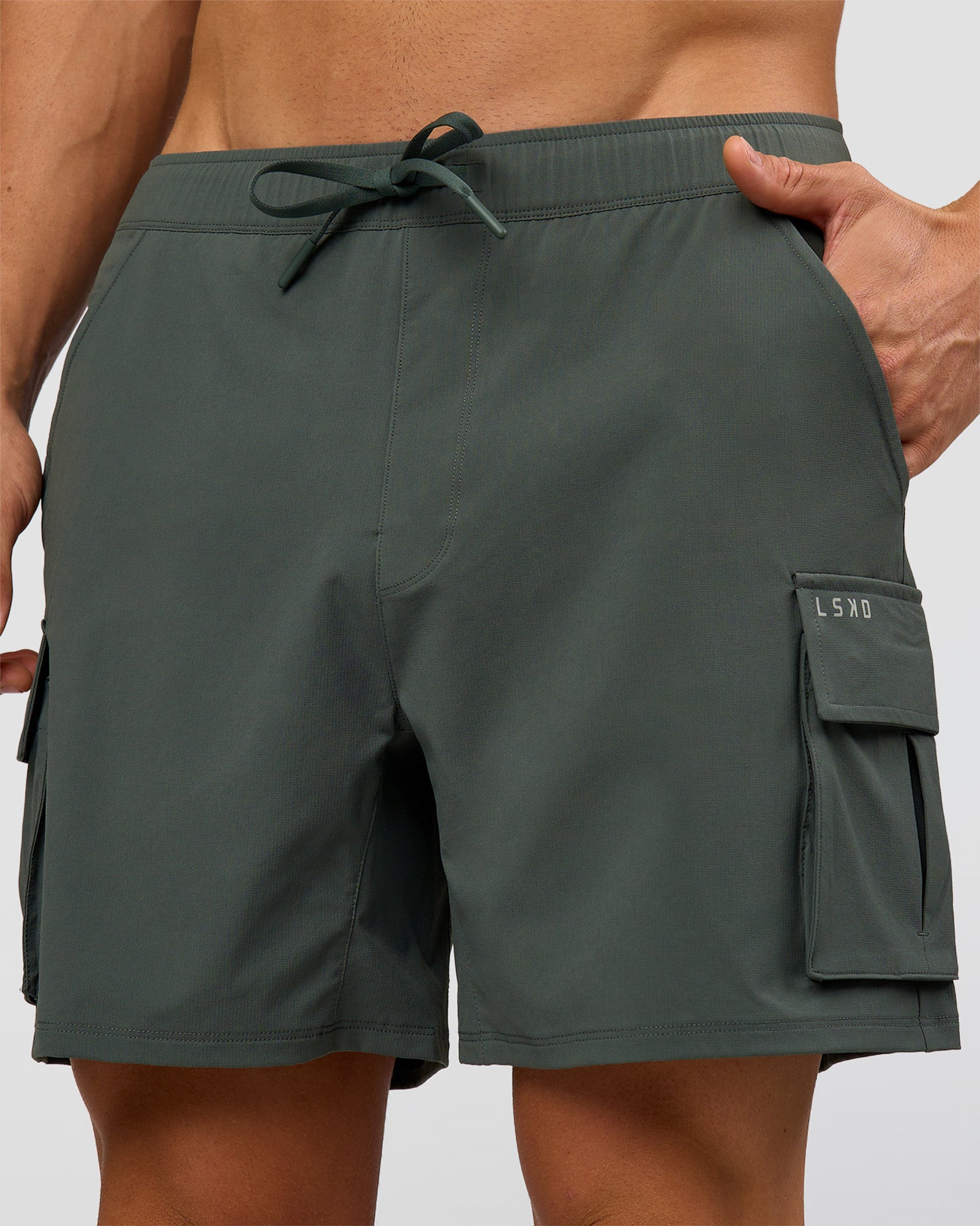 Man wearing Functional Cargo 6" Short - Carbon Green | Model:Albert | Size:M
