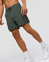 Man wearing Functional Cargo 6" Short - Carbon Green | Model:Albert | Size:M