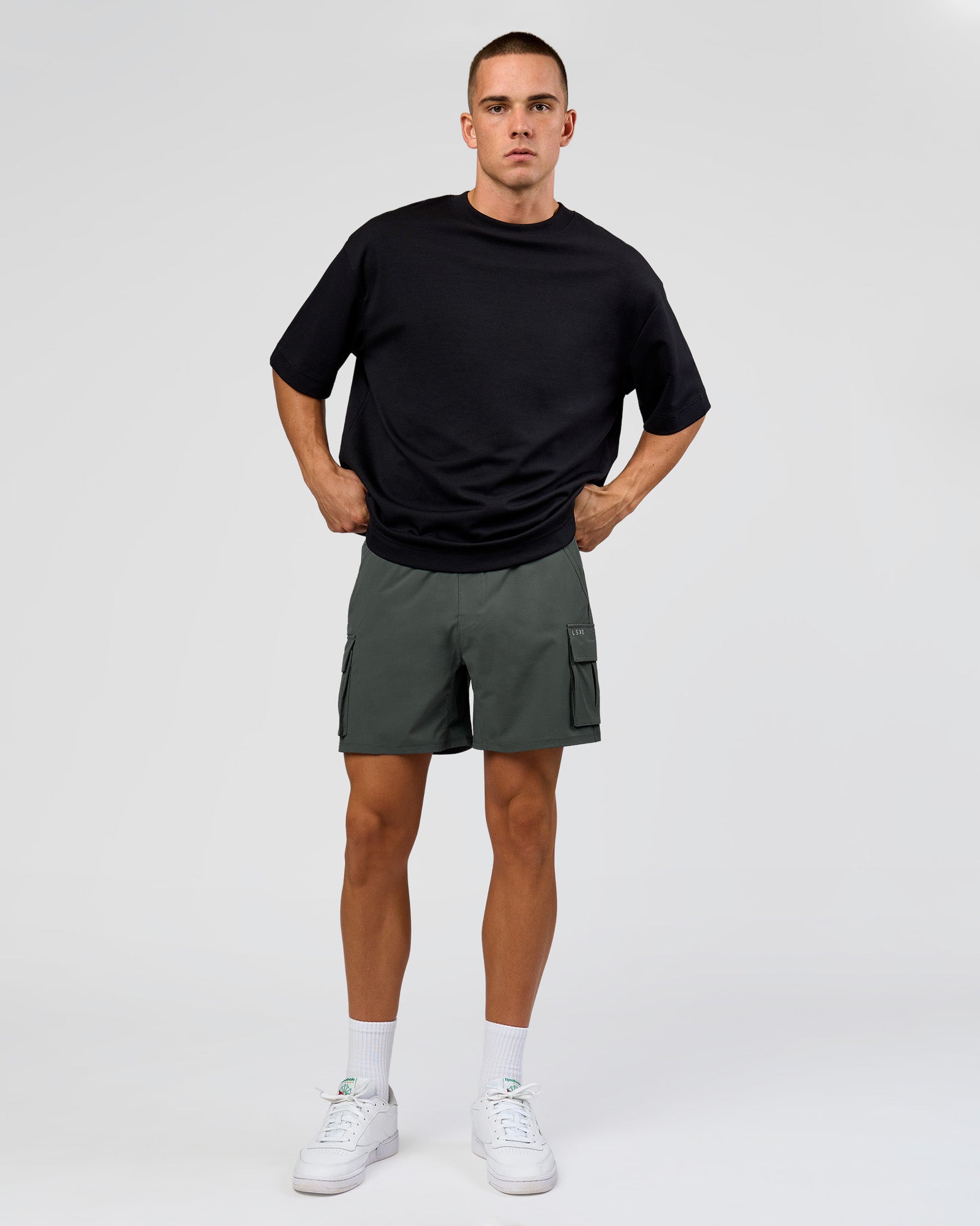 Man wearing Functional Cargo 6" Short - Carbon Green | Model:Albert | Size:M