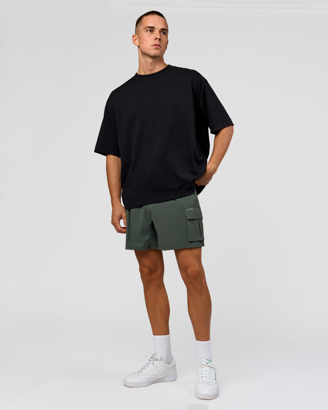 Man wearing Functional Cargo 6" Short - Carbon Green | Model:Albert | Size:M