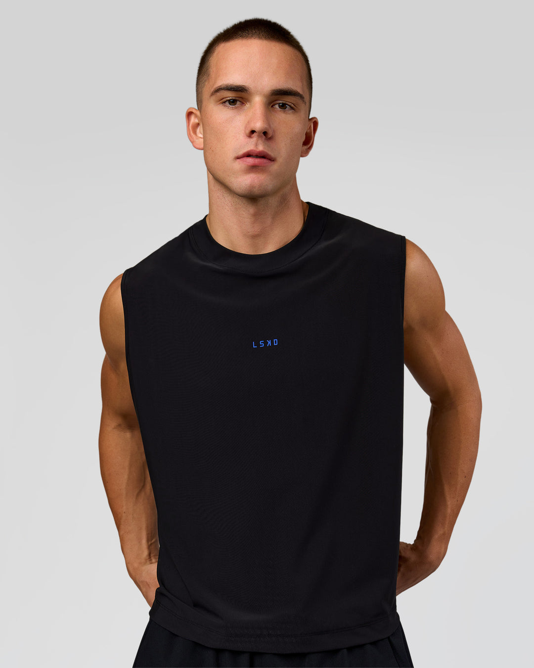 Man wearing Run Club Elevate Muscle Tank - Black-Electric Indigo | Model:Albert | Size:M
