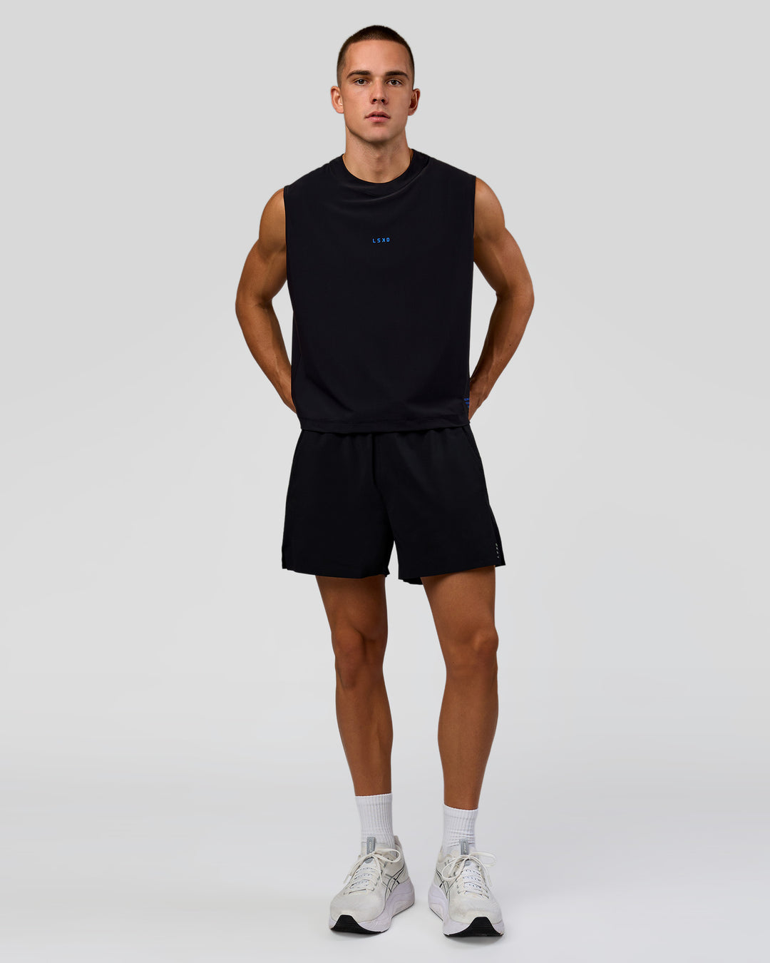 Man wearing Run Club Elevate Muscle Tank - Black-Electric Indigo | Model:Albert | Size:M