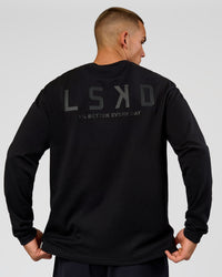 Man wearing Tonal Legacy Heavyweight Oversized LS Tee - Black-Black | Model:Albert | Size:M | Thumbnail Index: 0