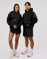 Man wearing Movember x LSKD Oversized Hoodie - Black | Model:George | Size:M | Thumbnail Index: 5