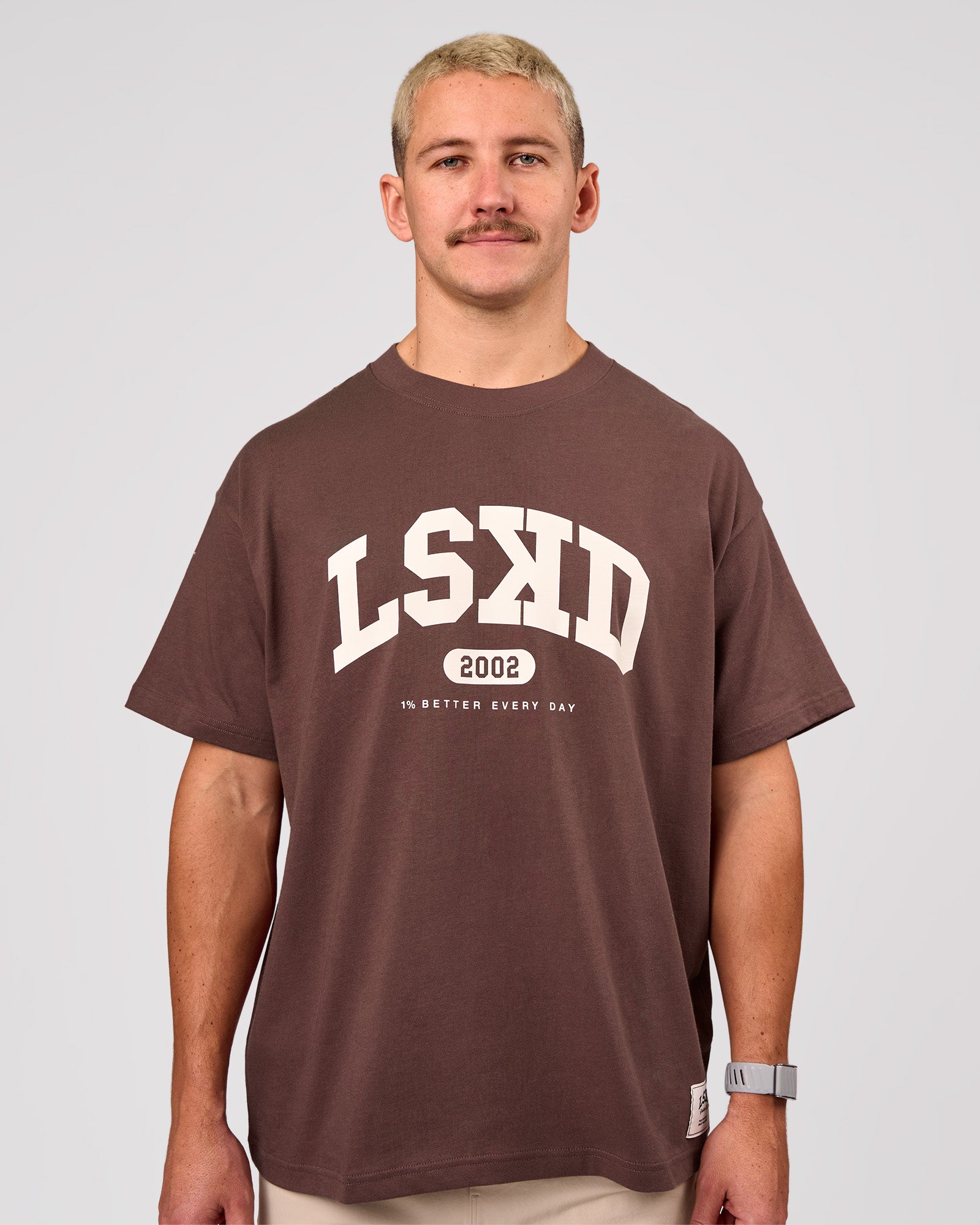 Man wearing Varsity EST Heavyweight Oversized Tee  - Cocoa Powder-Off White | Model:Jaiden | Size:M