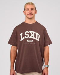 Man wearing Varsity EST Heavyweight Oversized Tee  - Cocoa Powder-Off White | Model:Jaiden | Size:M | Thumbnail Index: 1