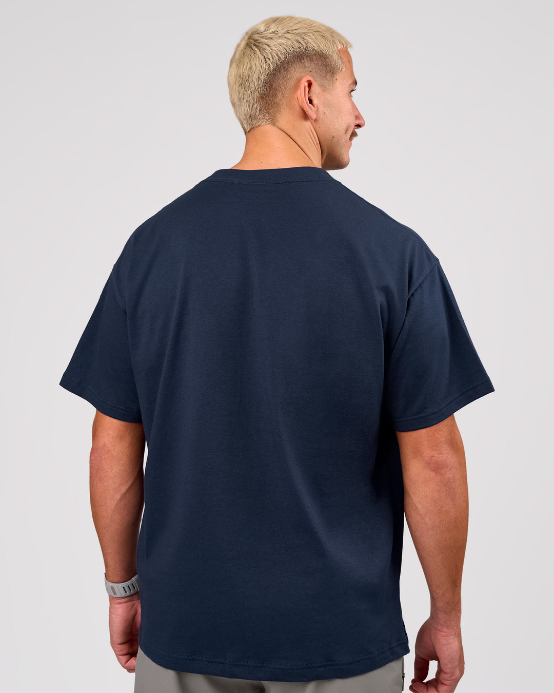 Man wearing Varsity EST Heavyweight Oversized Tee  - Future Navy-White | Model:Jaiden | Size:M - view 10