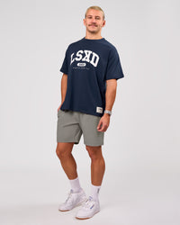 Man wearing Varsity EST Heavyweight Oversized Tee  - Future Navy-White | Model:Jaiden | Size:M | Thumbnail Index: 10