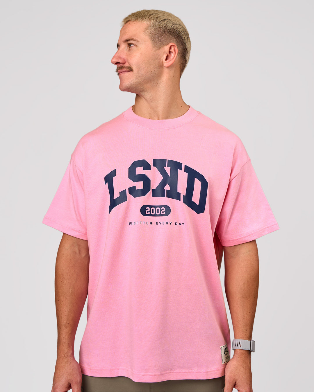 Man wearing Varsity EST Heavyweight Oversized Tee  - Pink Rose-Future Navy | Model:Jaiden | Size:M - view 8