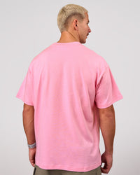 Man wearing Varsity EST Heavyweight Oversized Tee  - Pink Rose-Future Navy | Model:Jaiden | Size:M | Thumbnail Index: 8