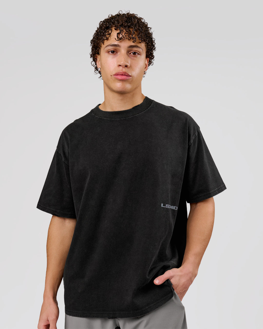 Man wearing Backline Washed Heavyweight Oversized Tee - Black Washed | Model:Leandro | Size:M - view 3