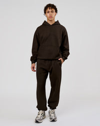 Man wearing Base Baggy Cuffed Track Pant - Ground Coffee | Model:Leandro | Size:M | Thumbnail Index: 1