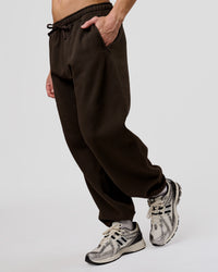Man wearing Base Baggy Cuffed Track Pant - Ground Coffee | Model:Leandro | Size:M | Thumbnail Index: 2