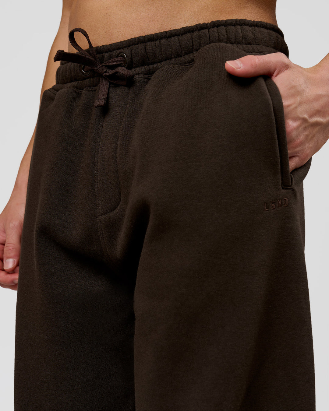 Man wearing Base Baggy Cuffed Track Pant - Ground Coffee | Model:Leandro | Size:M - view 4