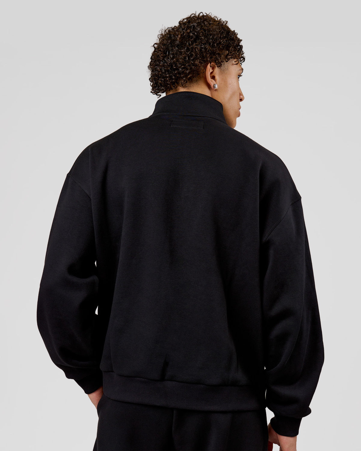 Man wearing Base Quarter Zip Sweater - Black | Model:Leandro | Size:M