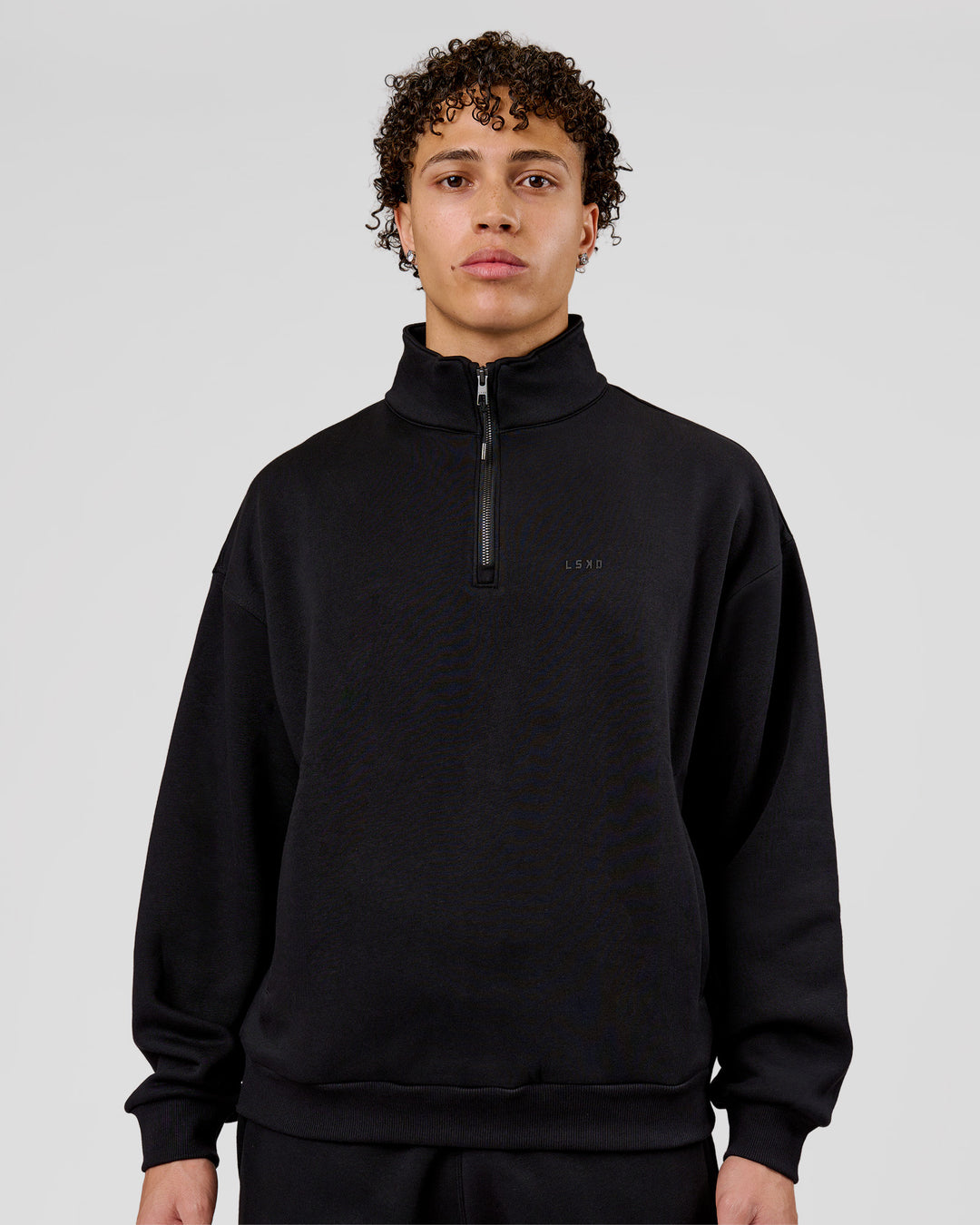 Man wearing Base Quarter Zip Sweater - Black | Model:Leandro | Size:M - view 1