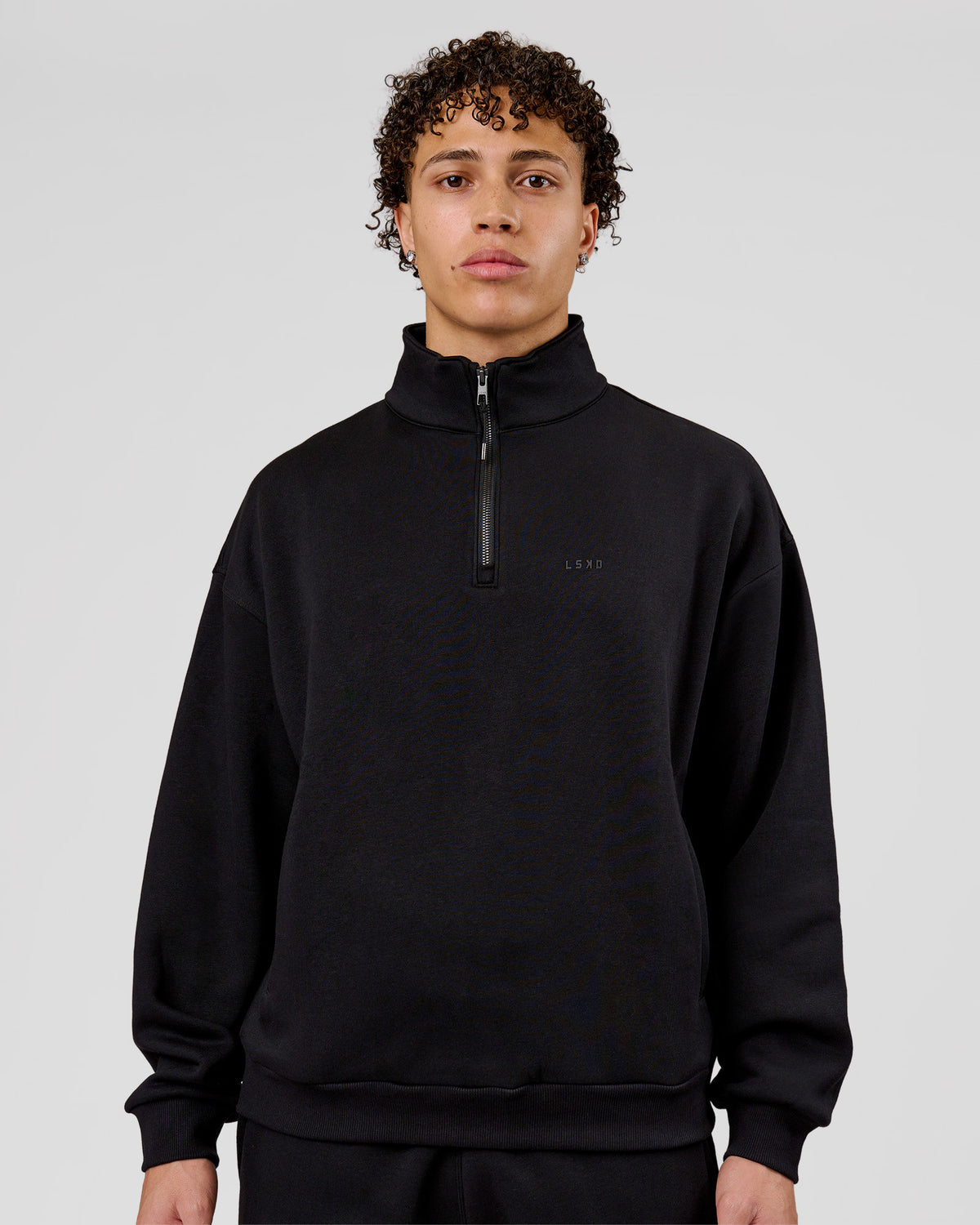Man wearing Base Quarter Zip Sweater - Black | Model:Leandro | Size:M