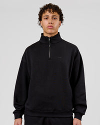 Man wearing Base Quarter Zip Sweater - Black | Model:Leandro | Size:M | Thumbnail Index: 0