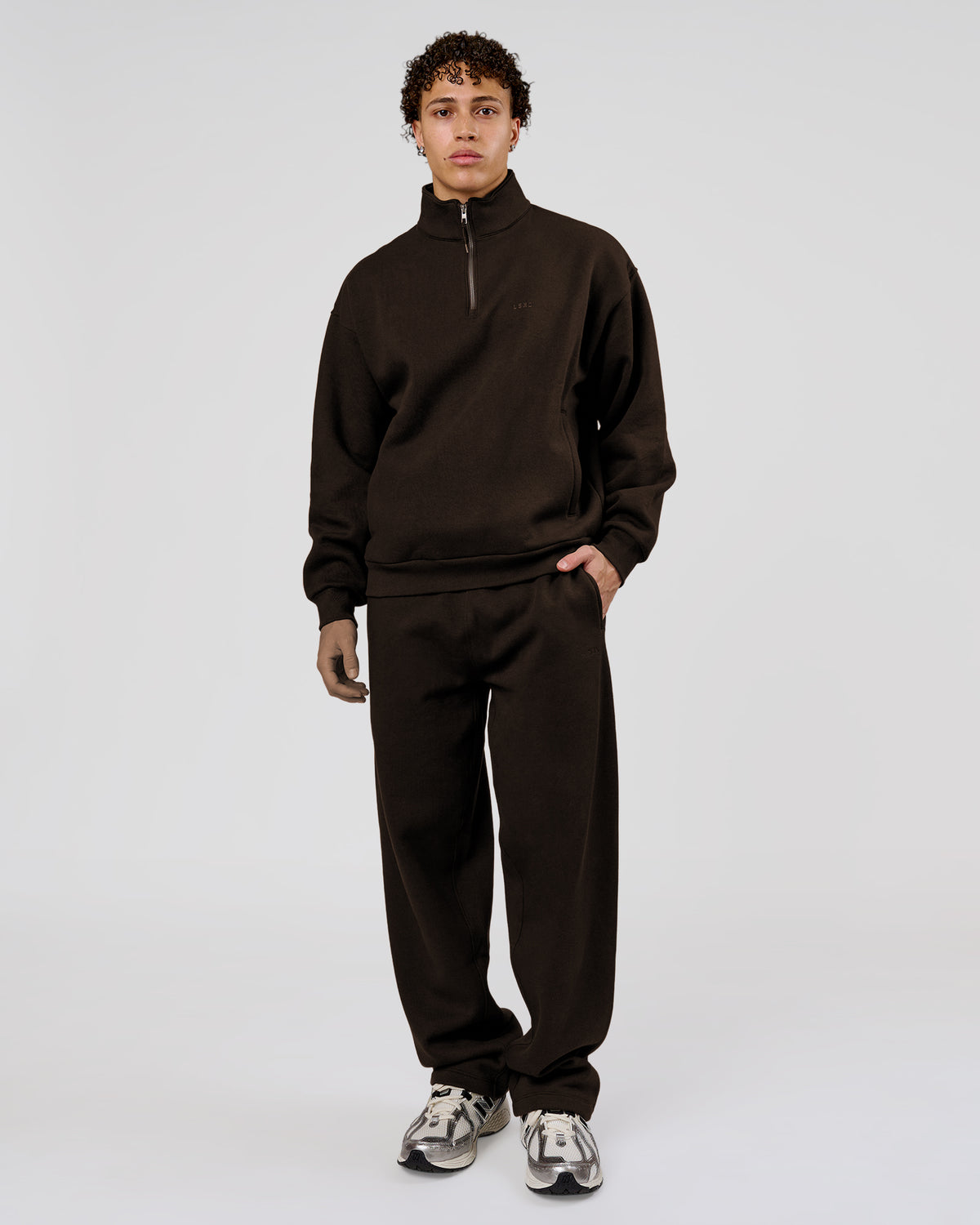 Man wearing Base Quarter Zip Sweater - Ground Coffee | Model:Leandro | Size:M