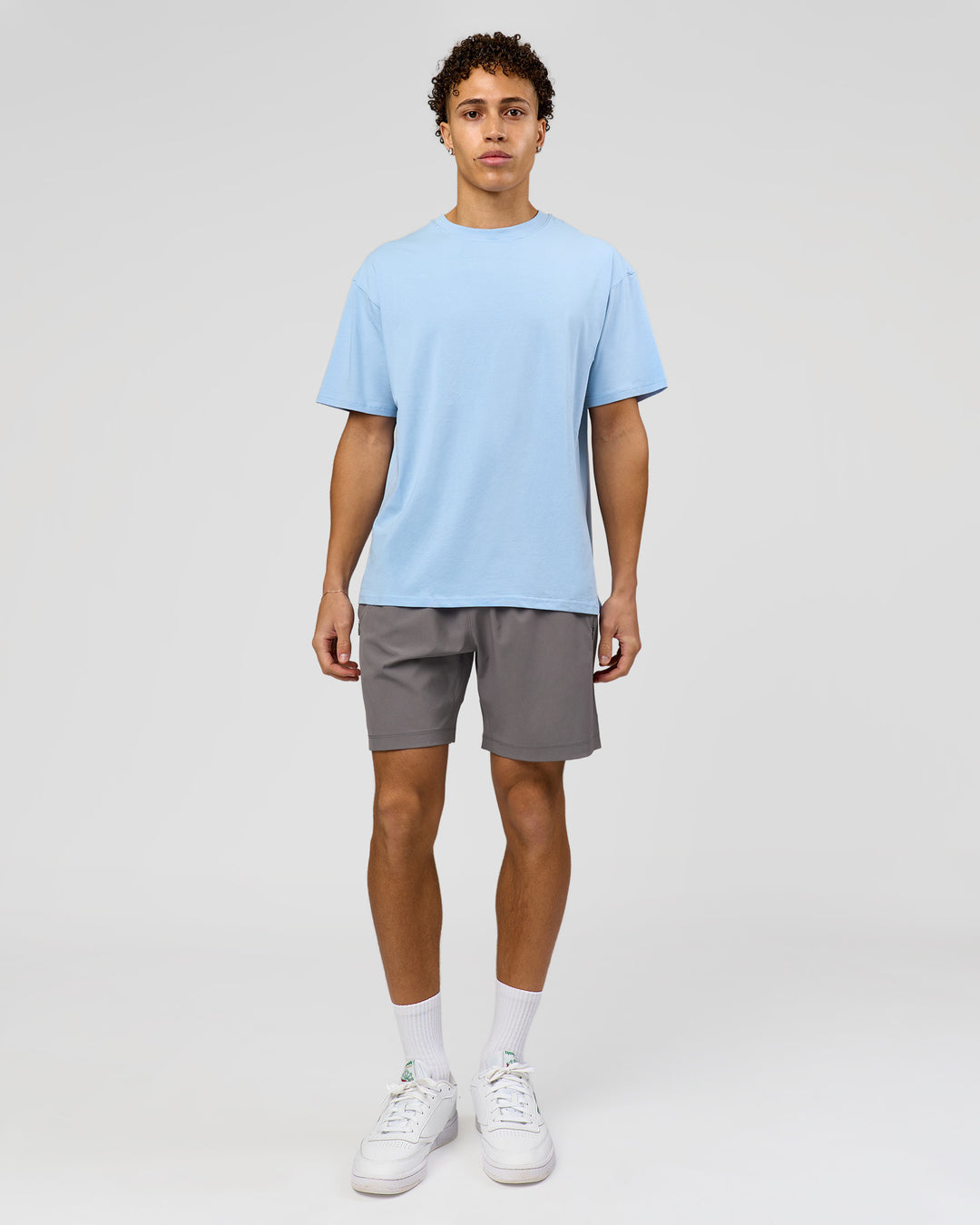 Man wearing Benchmark FLXCotton Oversized Tee - Open Air-Blue Bell | Model:Leandro | Size:M