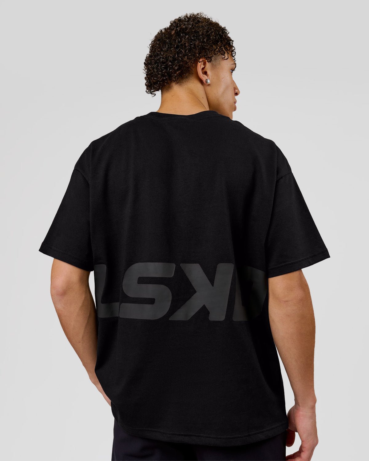 Man wearing Shadow Mark Heavyweight Oversized Tee - Black-Onyx | Model:Leandro | Size:M