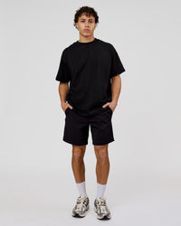 Man wearing Shadow Mark Heavyweight Oversized Tee - Black-Onyx | Model:Leandro | Size:M | Thumbnail Index: 12