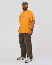 Man wearing VS6 1% Better Fathers Day FLXCotton Oversized Tee - Warm Apricot | Model:Jordan | Size:XL | Thumbnail Index: 10