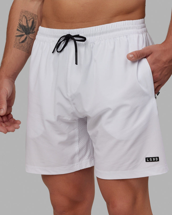 Man wearing Rep 7" Performance Short - White