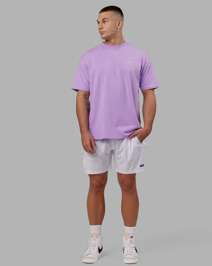 Man wearing Rep 7" Performance Short - White