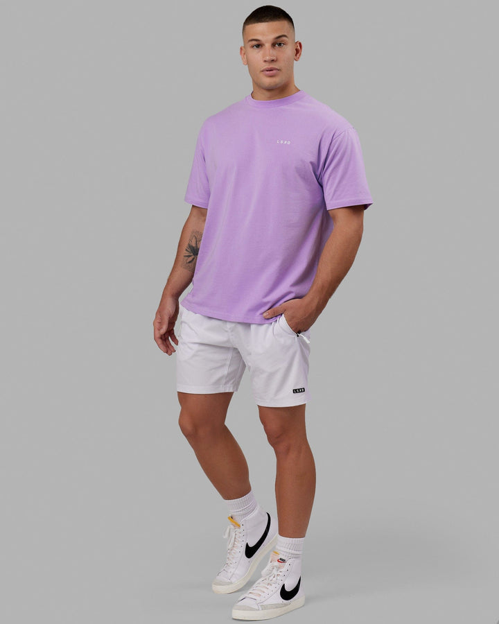Man wearing Rep 7" Performance Short - White