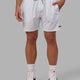 Man wearing Rep 7" Performance Short - White