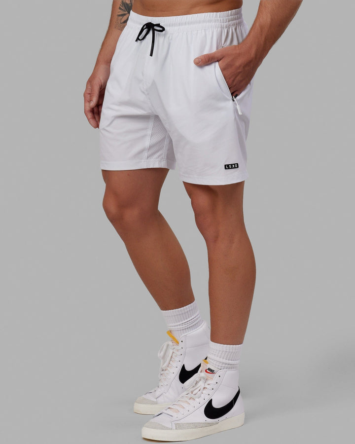Man wearing Rep 7" Performance Short - White
