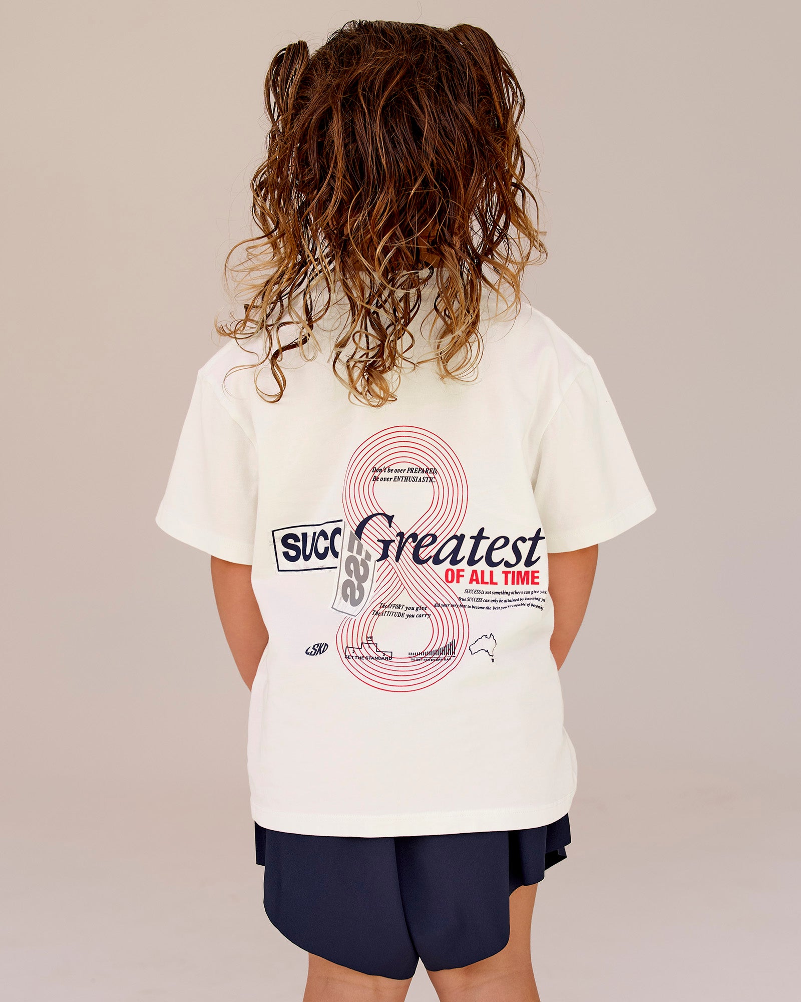 Studio image of Kids Greatest of All Time FLXCotton Tee - Off White Washed-Scarlet