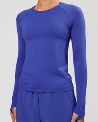 Woman wearing Aeroflx+ Seamless Long Sleeve Tee in Power Cobalt | Model: Issy | Size: XS | Thumbnail Index: 5