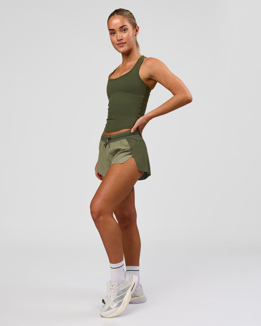Woman wearing Accelerate 3" Mid-Rise Running Short - Pure Olive-Fog | Model:Xs | Size:ISSY - view 8