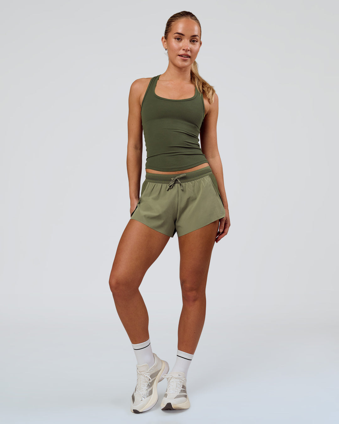 Woman wearing Accelerate 3" Mid-Rise Running Short - Pure Olive-Fog | Model:Xs | Size:ISSY - view 3