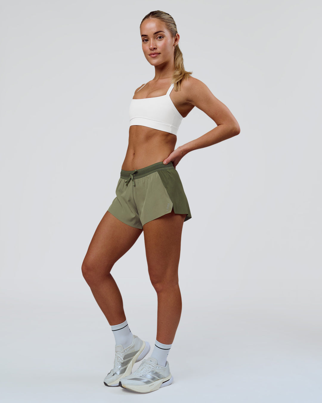 Woman wearing Accelerate 3" Mid-Rise Running Short - Pure Olive-Fog | Model:Xs | Size:ISSY - view 2