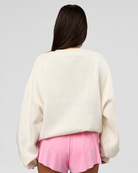Woman wearing Varsity Boxy Crew - Off White-Pink Rose | Model:Bianca | Size:L
