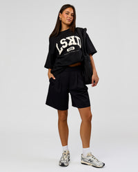 Woman wearing Varsity EST Heavyweight Oversized Tee  - Black-Off White | Model:Bianca | Size:L