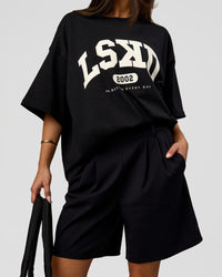 Woman wearing Varsity EST Heavyweight Oversized Tee  - Black-Off White | Model:Bianca | Size:L