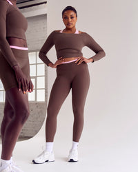 Woman wearing Bree Fusion High-Rise Full Length Legging Pockets - Cocoa Powder-Pink Rose | Model:Cass | Size:L | Thumbnail Index: 2