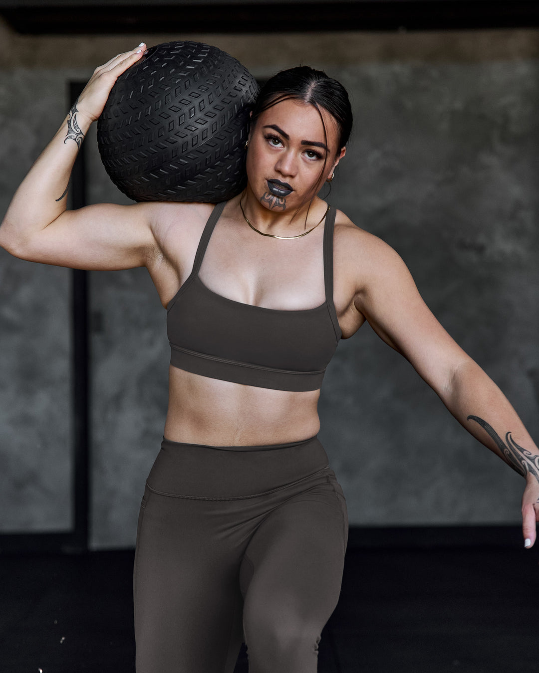 Woman wearing Momentum Sports Bra - Onyx | Model:Terai | Size:M - view 3
