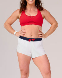 Woman wearing Accelerate 3" Mid-Rise Running Short - White-Future Navy | Model:Tia | Size:M | Thumbnail Index: 2