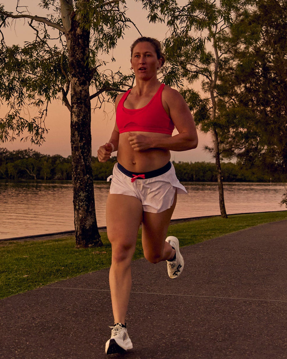 Woman wearing Accelerate 3" Mid-Rise Running Short - White-Future Navy | Model:Tia | Size:M - view 1
