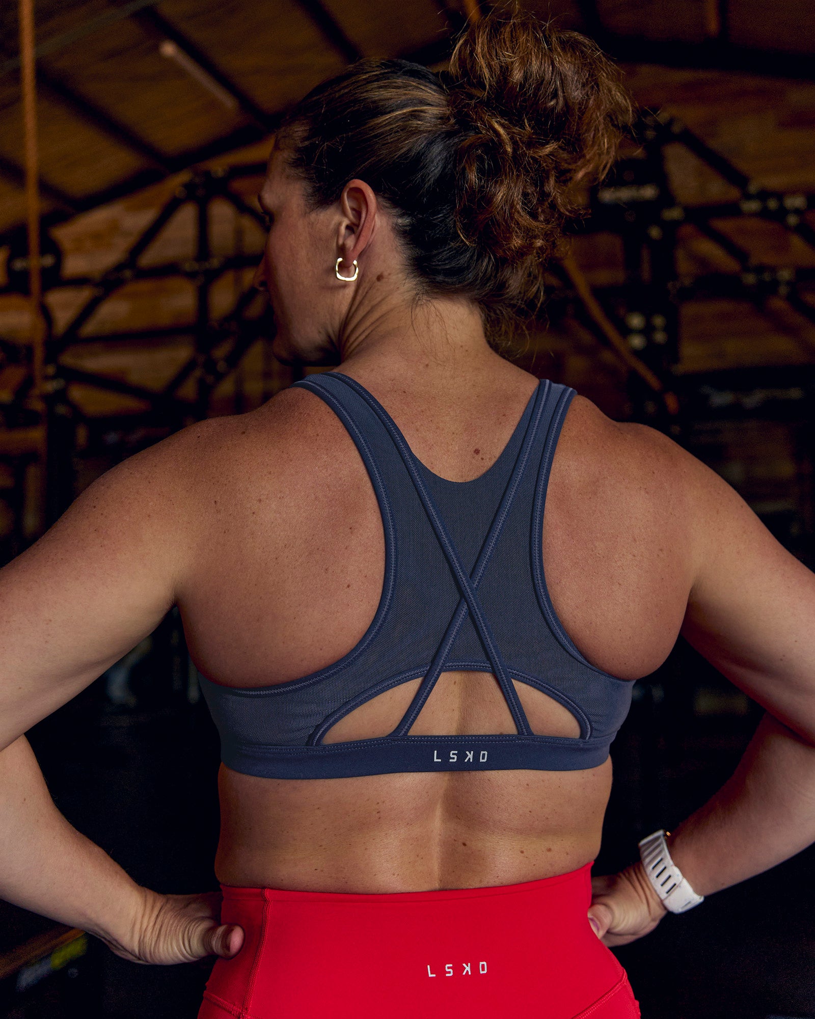 Woman wearing Unstoppable Racerback Sports Bra - Future Navy | Model:Tia | Size:M