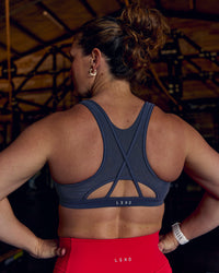 Woman wearing Unstoppable Racerback Sports Bra - Future Navy | Model:Tia | Size:M | Thumbnail Index: 0